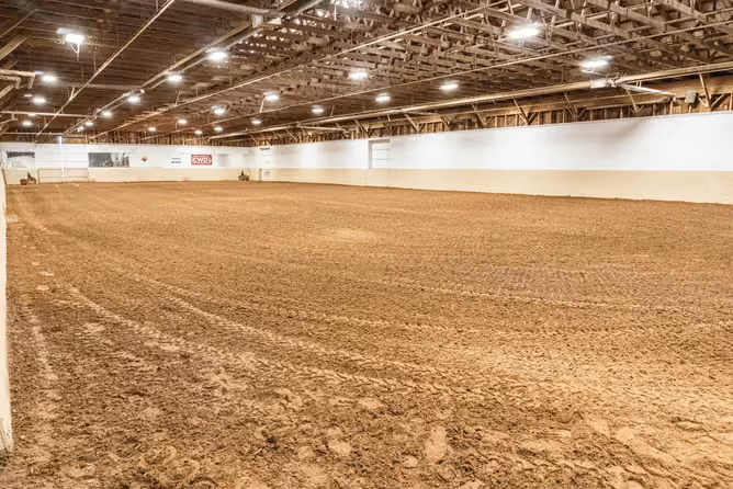 The indoor arena and its riding surface